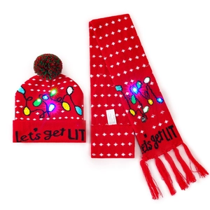 Detail of red LED knit Christmas hat and scarf set with glowing Let's get LIT letters