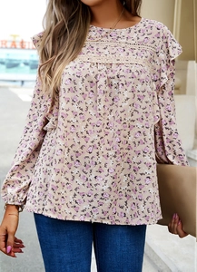 Detail of floral blouse with elegant lace collar and ruffled sleeve design for women