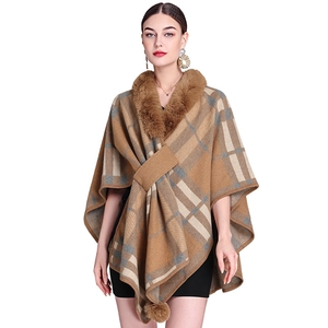 Brown plaid knit poncho with faux rabbit fur collar and decorative pom-poms on hem