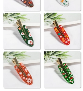 Detail view of festive resin Christmas hair clips with gold metal back clips