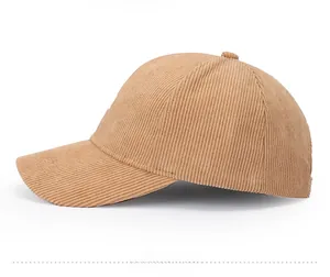 Side view of a brown corduroy baseball cap with thick textured fabric and curved brim