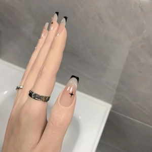 French tip press-on nails with black cat eye star patterns and silver glitter accents