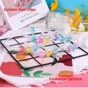 Detail of candy-colored headbands with glitter heart charms for girls on lace background