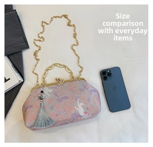 Chinese style shell bag with butterfly clasp showing interior space for a phone