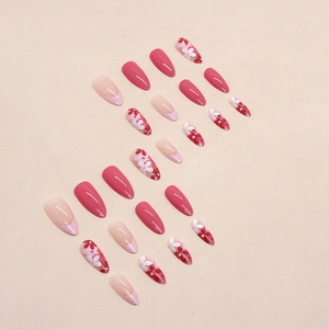 Pink almond press-on nails set with floral patterns and French tip art design