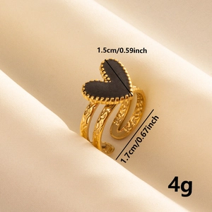 Macro detail of golden heart ring with black inlay showing size dimensions and 4g weight