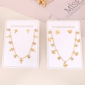 Detail of stainless steel jewelry sets with cross and butterfly charms and zircon stones