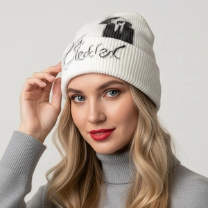 White knit beanie with black handwritten graffiti lettering and street style aesthetic