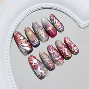 Metallic press on nails with purple and gold galaxy swirl design on mirror tray