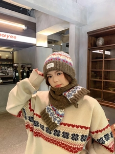 Detail of vintage Fair Isle knit pattern with heart and snowflake motifs on warm winter hat