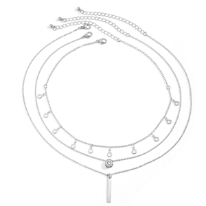 Detail view of silver layered necklace set with rhinestone disc and geometric pendants