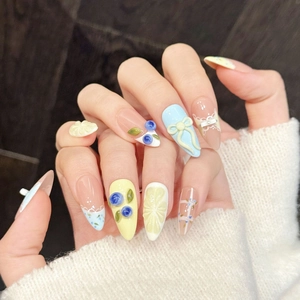 Pastel pink and yellow press-on nails with 3D lemon, blueberry, and lace details