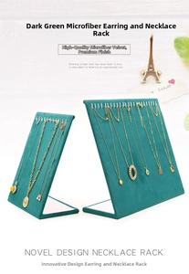 Detail of dark green microfiber display stands showcasing gold necklaces and earrings