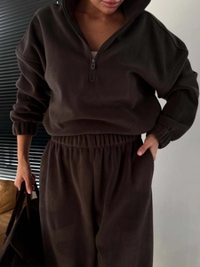 Detail of dark brown polar fleece set showing half-zip sweatshirt and matching joggers