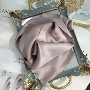 Detail view of the soft silk texture on a vintage gold frame and mirror tray