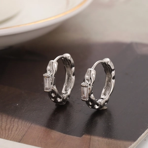 Silver geometric hoop earrings with hammered texture and rectangular zircon stones