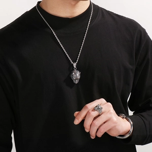Men's silver tiger head jewelry set including necklace, ring and bracelet worn by model