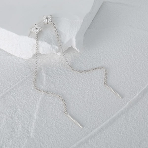 Detail of S925 sterling silver drop earring with zirconia clover and long chain tassel