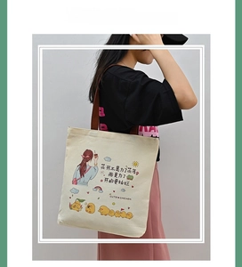 Detail of canvas tote bag with a cute cartoon girl illustration and sturdy handles