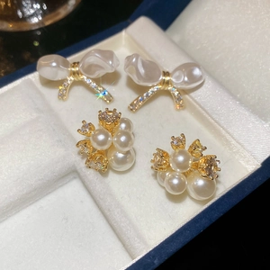 Elegant gold plated bow and pearl flower earrings set with sparkling zircon stones