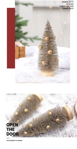 Macro shot of mini pine needle Christmas trees with gold glitter and wooden bases