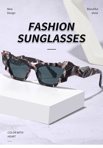 Detail of irregular cat-eye sunglasses with marble texture on minimalist background