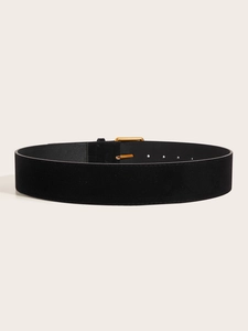 Detail of wide black velvet belt with golden metal buckle for retro waist slimming look