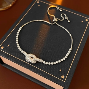 Detail of adjustable knot tennis bracelet with sparkling cubic zirconia on gift box