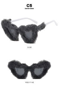 Detail view of heart-shaped grey plush sunglasses with black lenses and white arms
