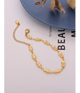 Close-up of gold fish link bracelet in 18k plated titanium steel with lobster clasp