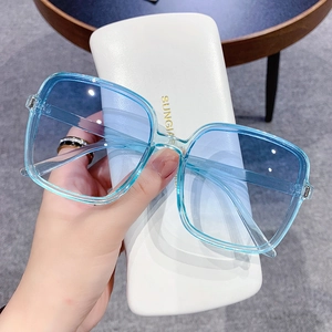 Fashionable square frame sunglasses with blue transparent frames and gradient lenses