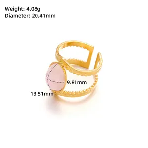 Detail view of gold titanium ring with pink teardrop stone showing 4.08g weight and 20mm size
