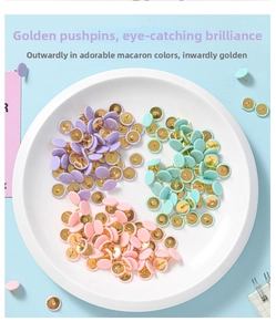Macaron colored push pins with gold metal base displayed in a decorative white tray