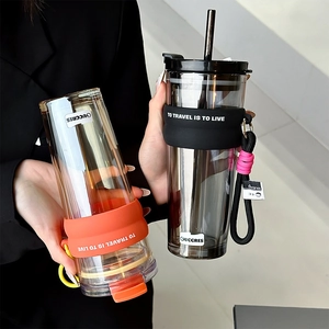 Vertical textured glass coffee mug with straw and protective silicone sleeve