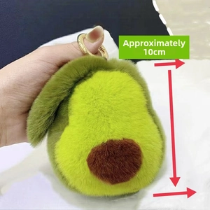 Close-up of cute plush avocado keychain made of real rabbit fur with golden metal clip