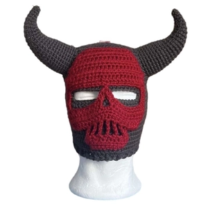 Handmade knitted skull balaclava with red demon horns on a white display head