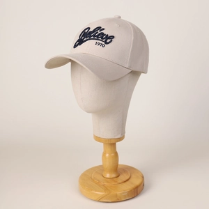Minimalist beige twill cotton baseball cap featuring navy blue Believe 1970 3D embroidery