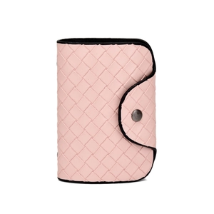 Close-up of pink woven leather wallet with black edge and metal snap button