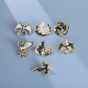Mythical creature enamel pin set featuring dragon and phoenix in black gold and white