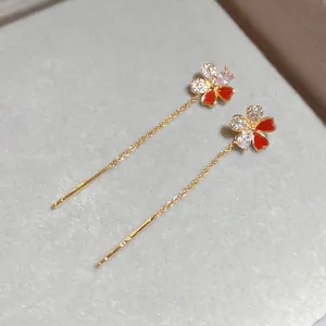 Elegant gold plated flower threader earrings with red enamel and sparkling zircon stones