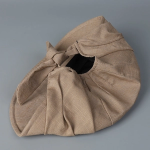 Detailed top view of khaki linen texture on the foldable cap with soft ribbon knot