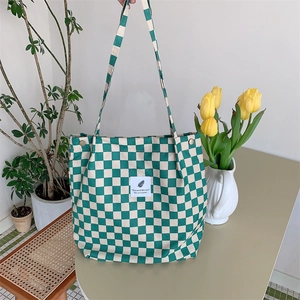 Detail of green and white checkerboard canvas tote bag with central stitched label