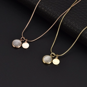 Elegant cat eye stone pendant necklaces in rose gold and gold on a dark textured background