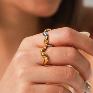 Two-tone stainless steel geometric ring featuring a polished olive leaf pattern