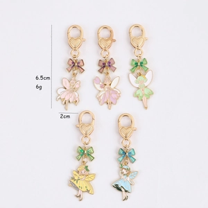 Set of five colorful fairy enamel keychains with golden heart clasps and bow charms
