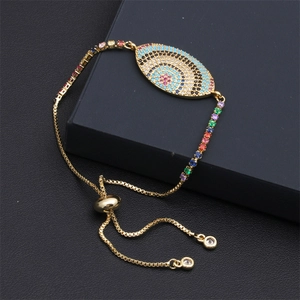 Macro shot of gold-plated evil eye bracelet with colorful cubic zirconia and adjustable slide clasp