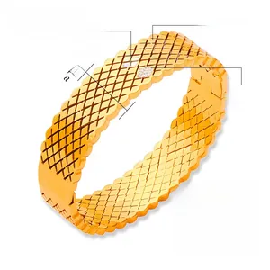 Detail showing 14.8mm wide gold titanium steel bangle with grid texture and crystals