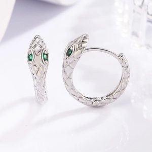 Minimalist silver snake hoop earrings with green gemstone eyes and scale texture