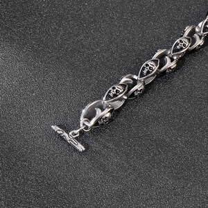 Macro shot of punk style stainless steel skull bracelet with vintage silver finish and OT clasp