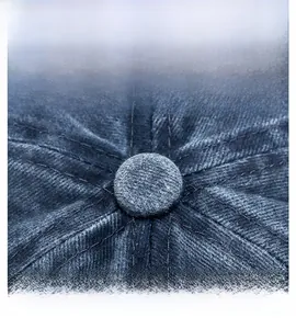 Detailed macro view of the navy blue cap top button and precision six-line stitching